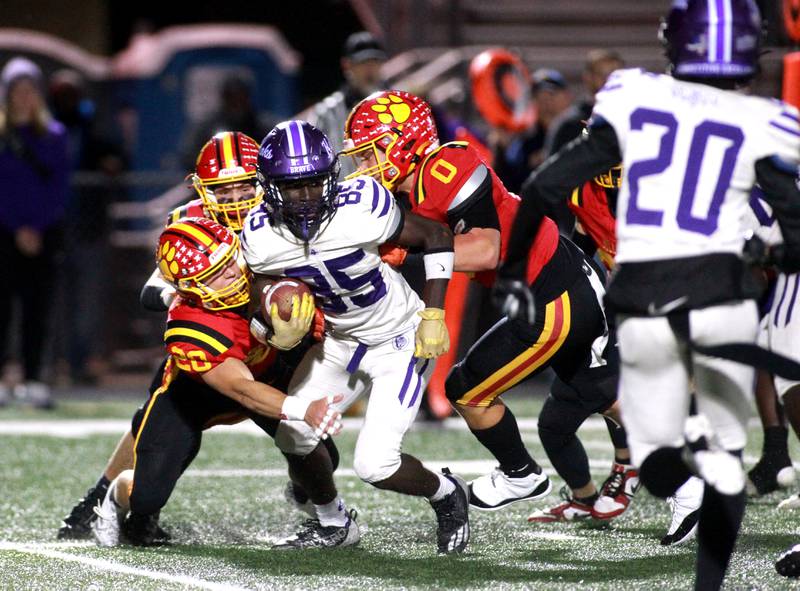 Collinsville’s Loyal Patterson is surrounded by Batavia defenders during a Class 7A first-round game on Friday, Nov. 1, 2024 in Batavia.