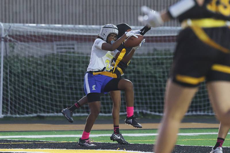 Joliet Central’s Ta’Niya Banks pulls in a pass for a touchdown against Joliet West on Wednesday, Oct. 2, 2024 in Joliet.