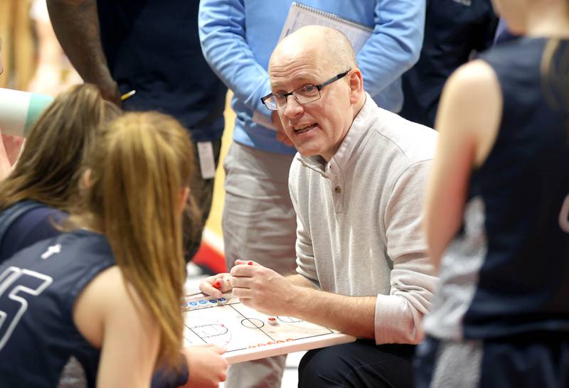 Nazareth head coach Eddie Stritzel talks to his team during a timeout in their Class 3A state semifinal game against Morton Friday, March 4, 2022, in Redbird Arena at Illinois State University in Normal.