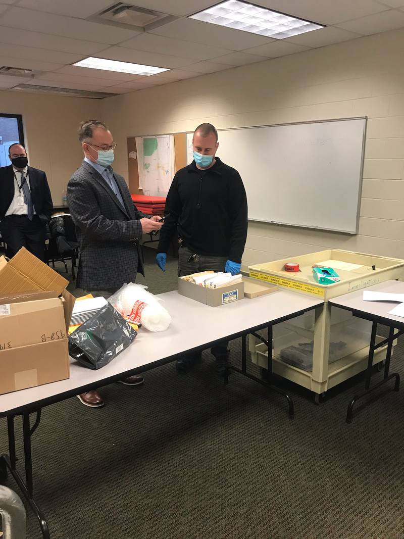 Andy Hale (left), attorney for Chester Weger, and Investigator Tyson Szafranski document the first batch of evidence from the Starved Rock murders Thursday, Dec. 9, 2021, before some items are transferred to a lab.