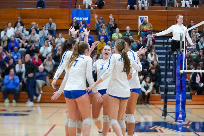 St. Charles North players celebrate after defeating Metea Valley in two sets during a Class 4A West Aurora Sectional semifinal volleyball match at West Aurora High School on Tuesday, Nov. 5, 2024.