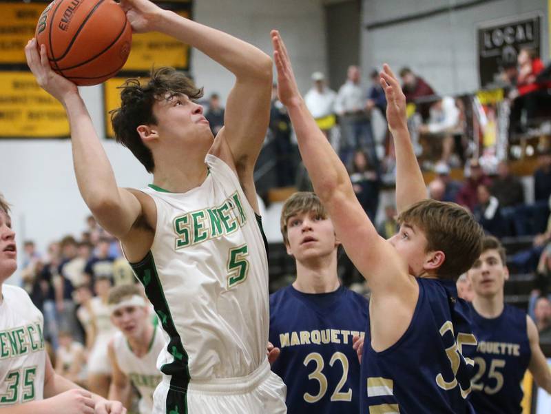Seneca's Kysen Klinker runs into the lane as Marquette's Peter McGrath defends during the Tri-County Conference championship game on Friday, Jan. 27, 2023 at Putnam County High School.