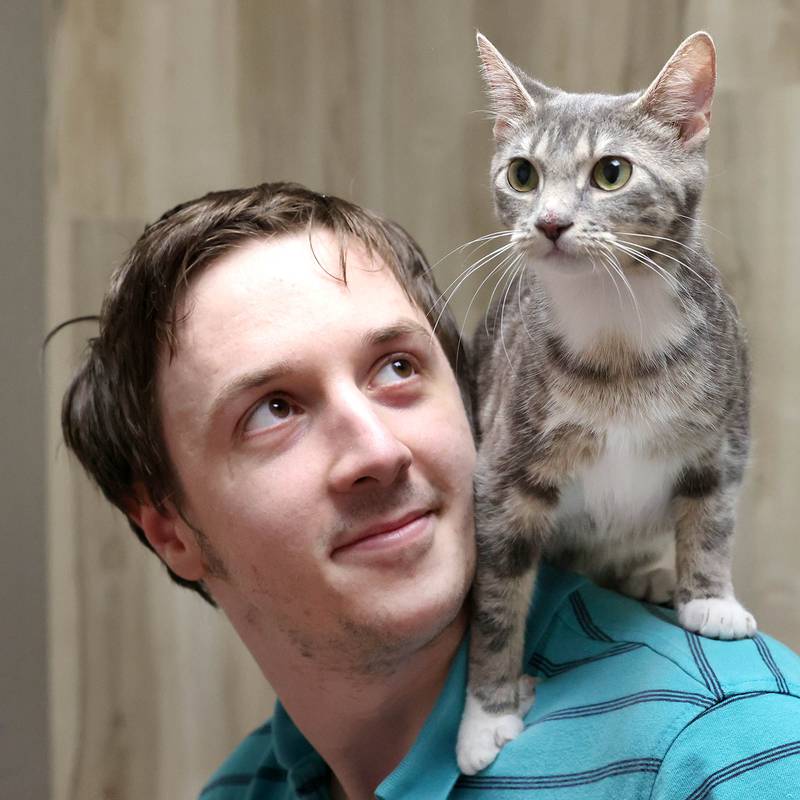 Keith Camenisch with a cat Monday, July 24, 2023, that soon may be available for adoption at Tails Humane Society in DeKalb. Tails will be hosting  the Tails on Tap Bar Crawl Saturday Aug. 5 in downtown DeKalb with all proceeds benefitting the homeless pets at the shelter.