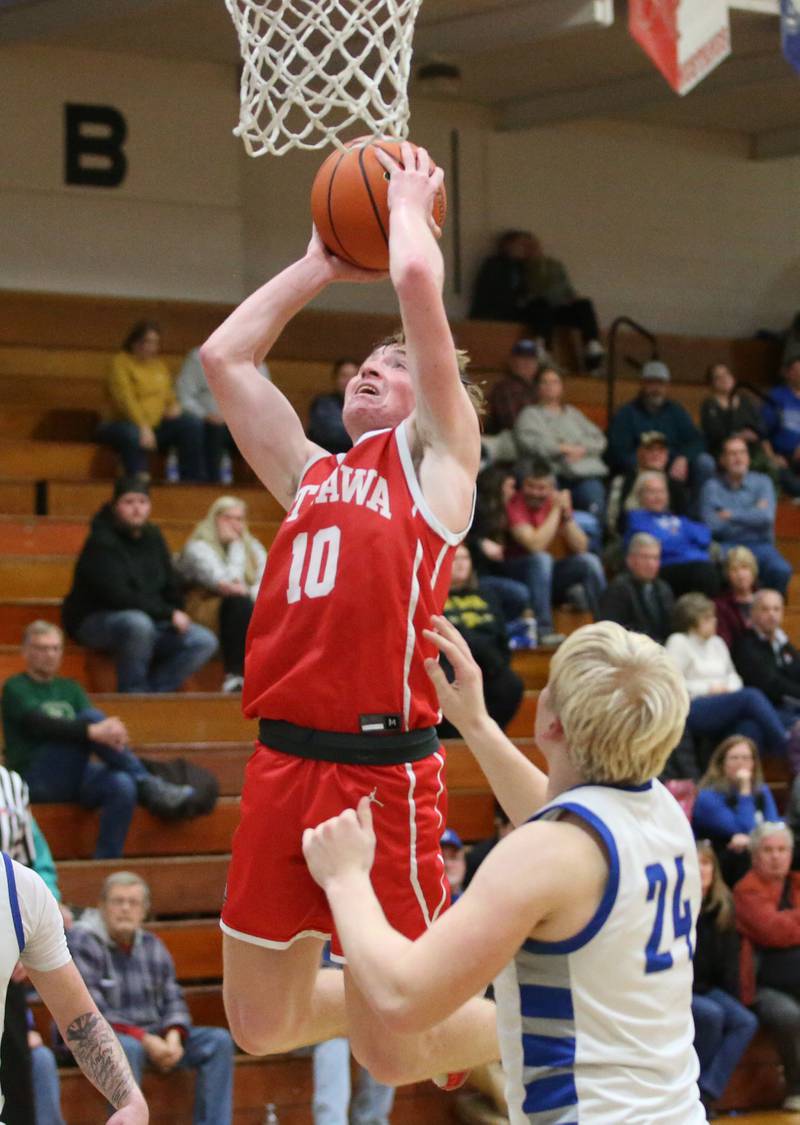 Ottawa's Evan Snook eyes the hoop over Princeton's Daniel Sousa on Monday, Feb. 5, 2024 at Prouty Gym.