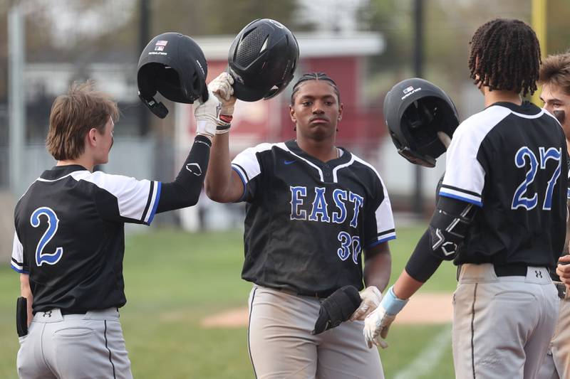Lincoln-Way East’s Justyn Hart is greeted at home plate after his 2nd two run homer against Lockport on Monday, April 22, 2024 in Lockport.