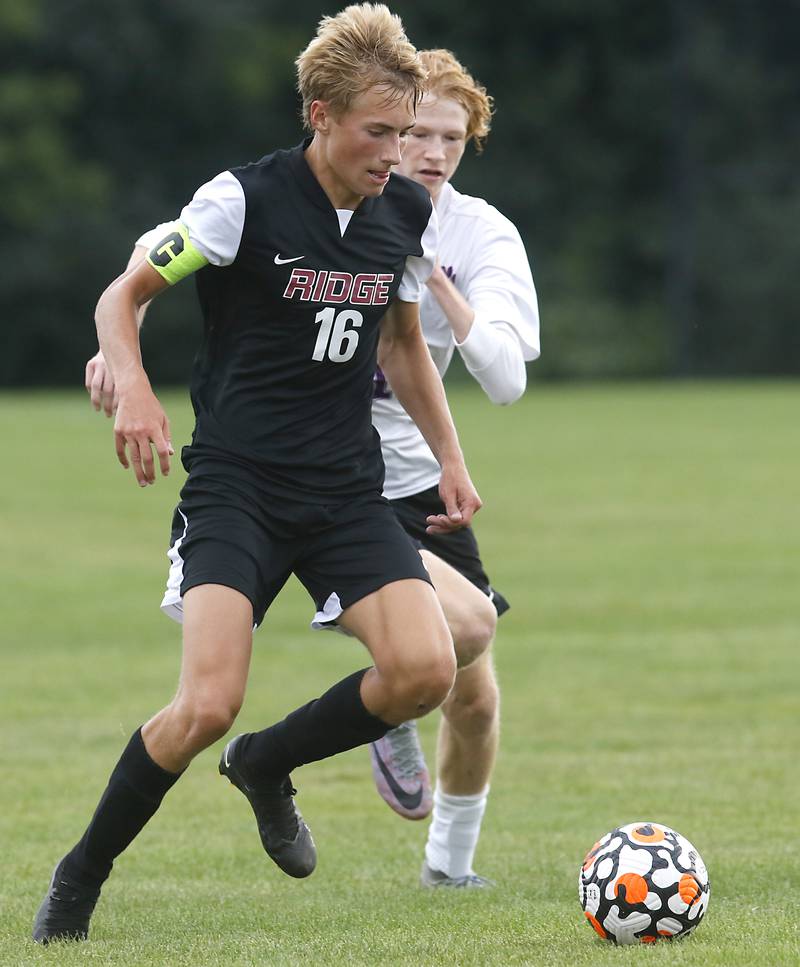 Prairie Ridge's Kaj Justesen controls the ball in front of Hampshire's Jackson Carey during a Fox Valley Conference soccer match Tuesday, Sept. 19, 2023, at Prairie Ridge High School in Crystal Lake.