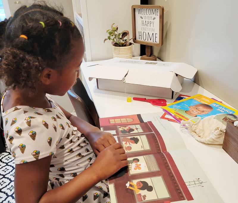 A Genoa student exploring the content of her kindergarten readiness toolkit.