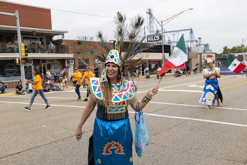 Paying homage to her ancestors, Sarah Castro walks through the Fiesta Days parade Saturday, Sept. 16, 2023. The parade started in Rock Falls before ending at Grandon Plaza in Sterling.