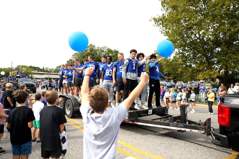 Geneva High School football players ride by on Friday, Sept. 27, 2024 during the school’s annual homecoming parade.