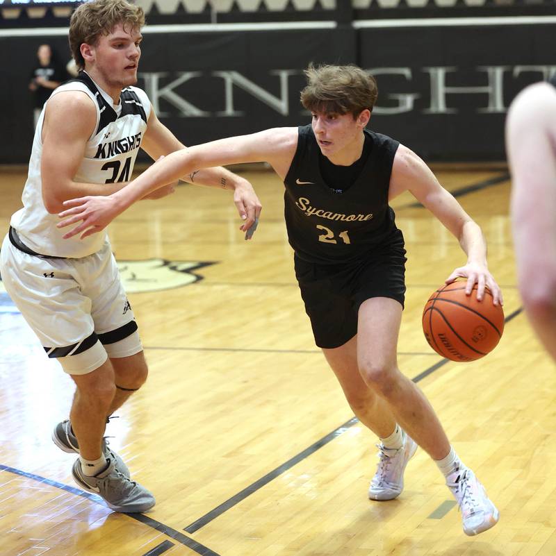 Sycamore's Ben Larry tries to drive by Kaneland's Parker Violett during their game Friday, Jan. 5, 2024, at Kaneland High School in Maple Park.
