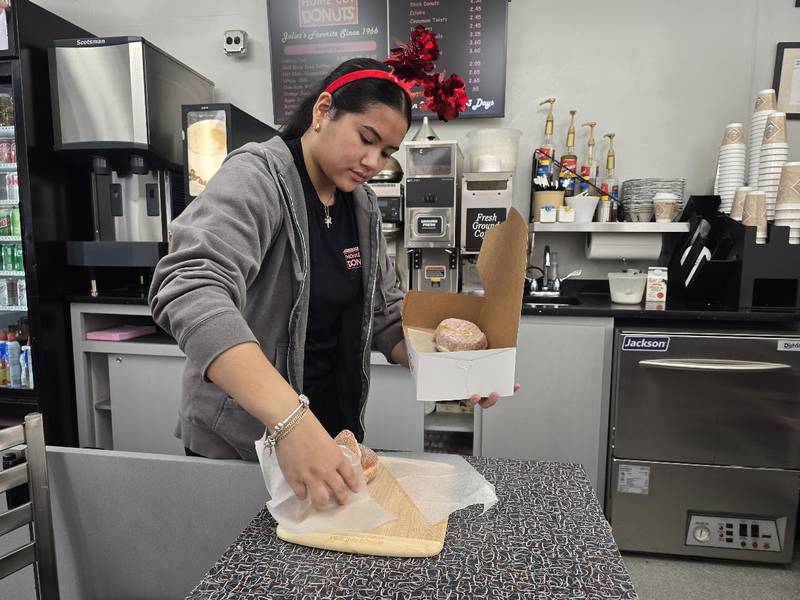KC Buan, a five-year employee at Home Cut Donuts in Joliet, packs a box of 
 Paczki, a traditional jelly-filled, doughnut-like pastry, which many people enjoy before the start of the Christian Lent, on Saturday, Feb. 14, 2026.
