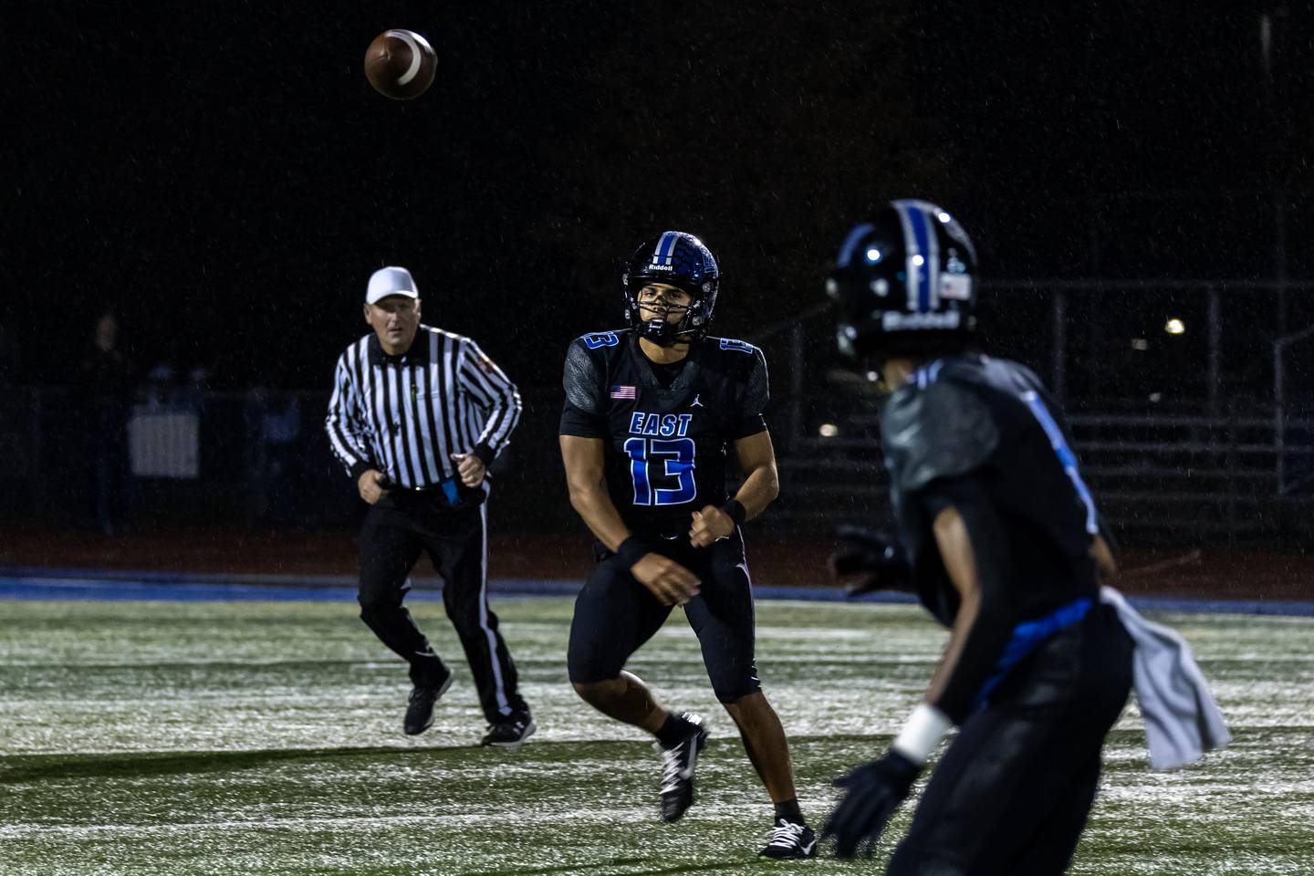 Lincoln-Way East's Jonas Williams passes to Chauncey Robinson during a varsity football round one playoff game against Stevenson at Lincoln-Way East on Oct. 31, 2025.