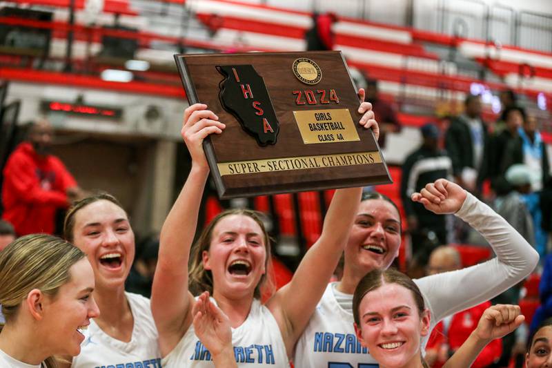 Nazareth celebrates after defeating Homewood-Flosmoor in the Class 4A girls supersectional basketball game. Feb 26, 2024..