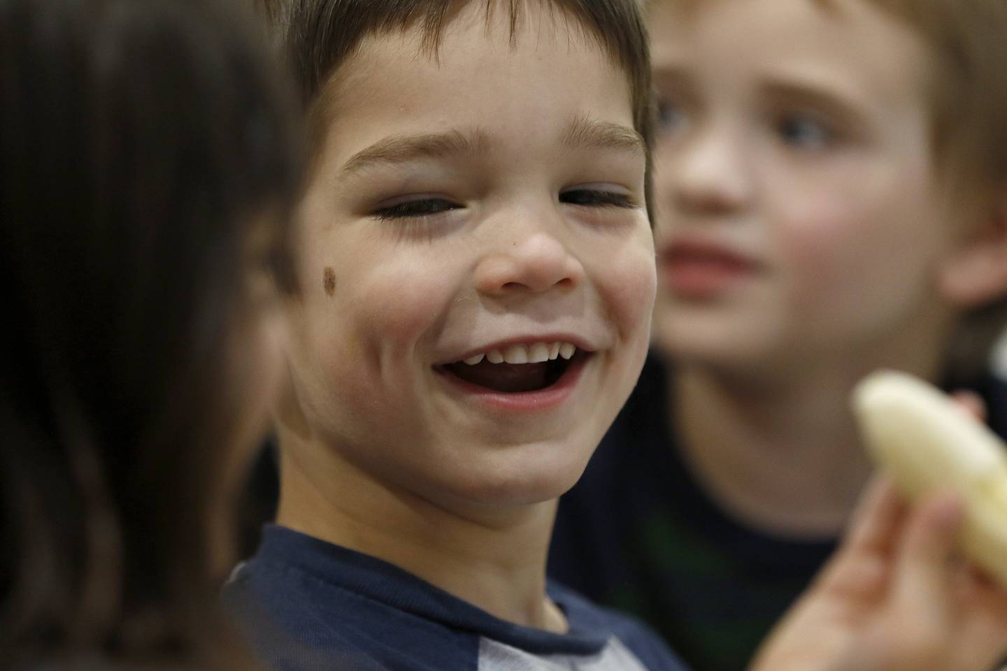 Jackson Leindecker lets out a laugh as he and friends eat bananas during a snack time Friday, April 30, 2021, at Little Hands Home Daycare and Preschool in Huntley.