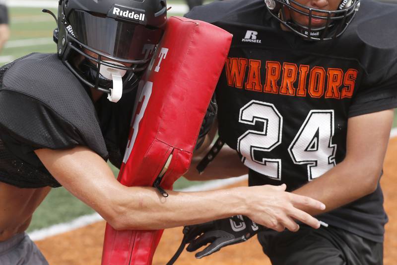 McHenry’s Dayton Warren practices tackling  during football practice on Thursday, July 24, 2025, at McCracken Field, in McHenry.