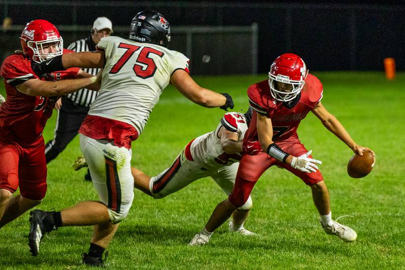 Dylan Glynn (7) of Hall runs ball as Derek Naftzger (51) of Erie-Prophetstown attempts to drag down on Friday, Sept 5, 2025 at Richard Nesti Stadium in Spring Valley.