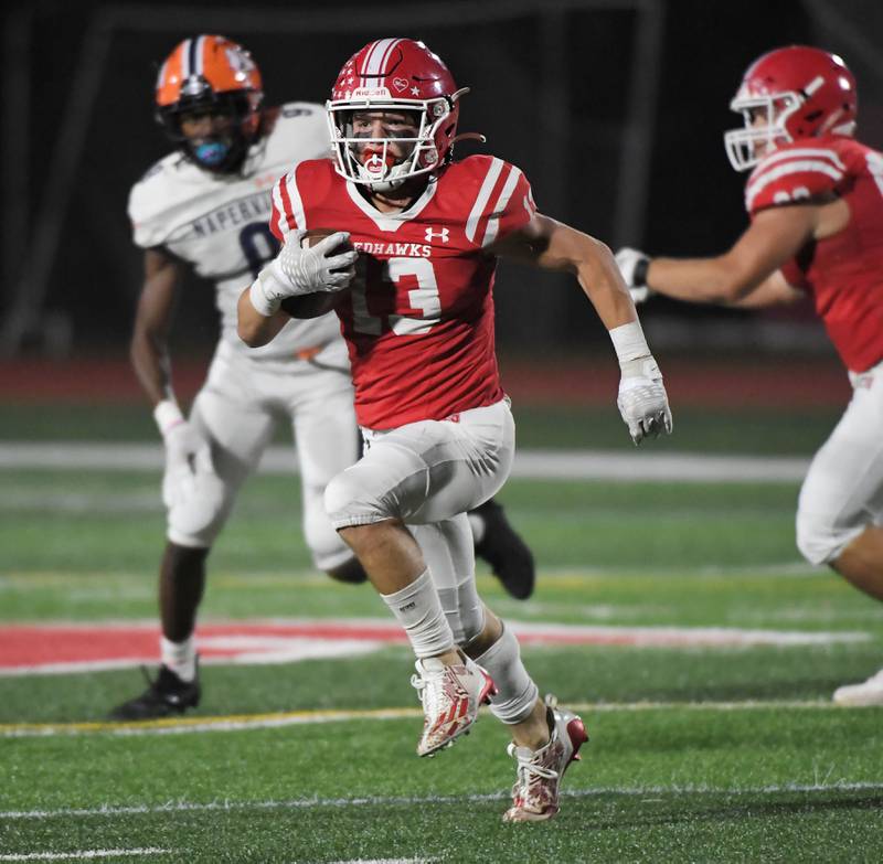 Naperville Central’s Aiden Clark runs against Naperville North in a high school football game at North Central College in Naperville on Friday, September 29, 2023.
