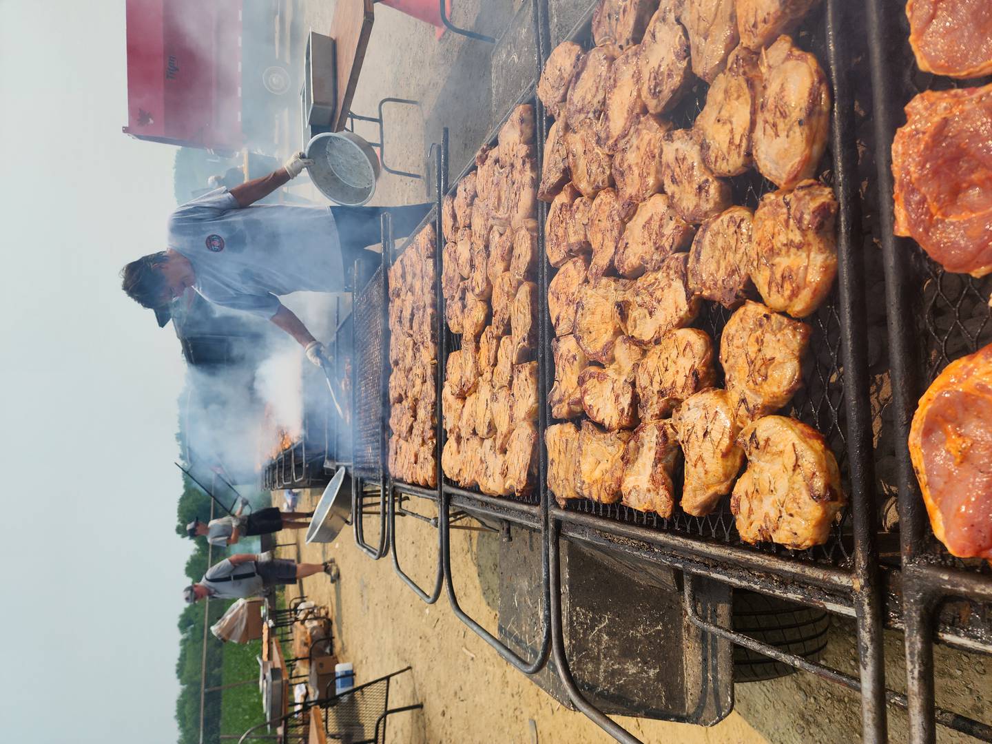 Mike Herbert manning the grills at Fay's finest Foods with Timothy and Jim Fay at far left. The company will provide chicken, pork chop and walleye dinners from 3 to 7 p.m. Thursday, July 3 for a scholarship fundraiser the Kane County Farm Bureau, 2N710 Randall Road, St. Charles.