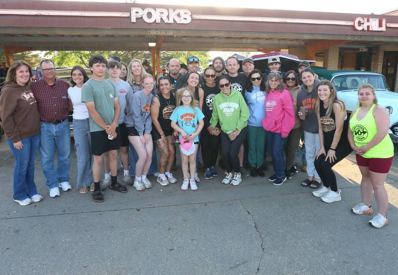 Former Root Beer Stand employees gather for a photo at the Root Beer Stand on Saturday, April 25, 2026 in Oglesby. The group gathered to rember Ron Moore, longtime owner who passed away on Wednesday. The restaurant also held their first Kick off Cruise in of the season. Donations from the cruise helped fund the Kids Hot Rod Camp held June 15-19 at "The Rock" Walnut Community Bible Church in Walnut. The camp is open to kids ages 12-17.