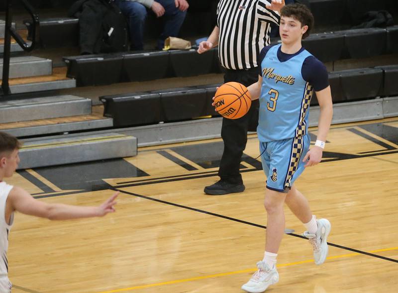 Marquette's Easton Debernardi dribbles down the court against Woodland during the Tri-County Conference Tournament championship on Friday, Jan. 30, 2026 at Putnam County High School.