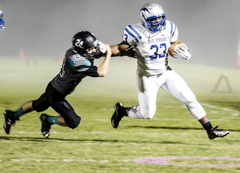 Woodstock North's Colin Ritter (left) tries to tackle Woodstock's Amari Wade while he runs the ball during the first quarter of Friday's football game at Woodstock North High School Oct. 14, 2016. Woodstock won, 34-6.