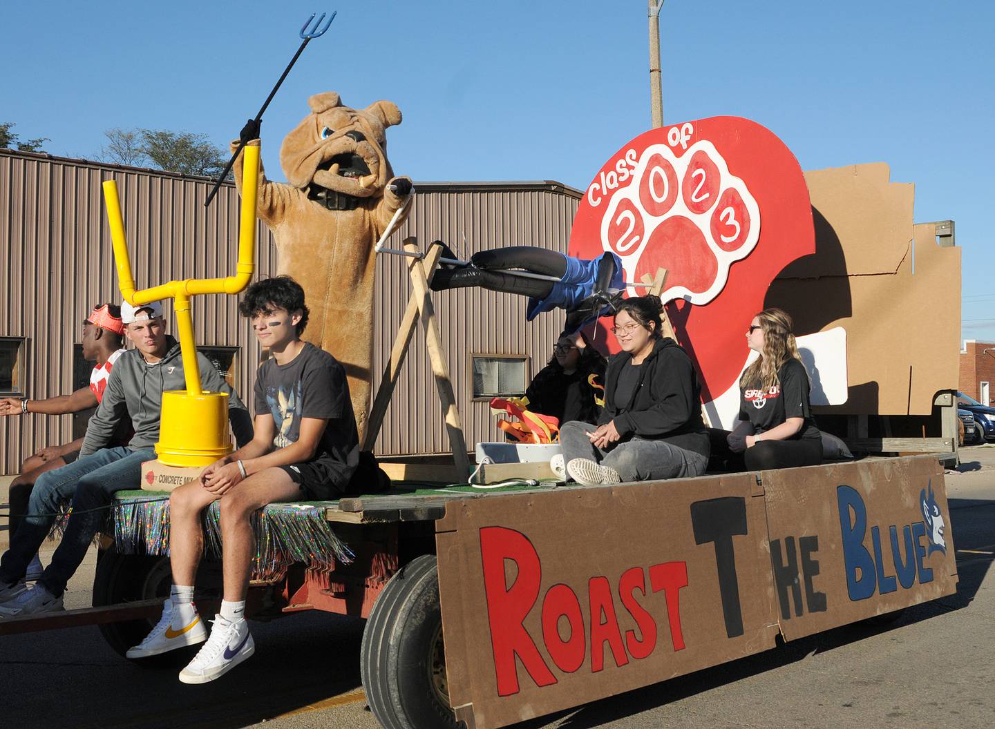 The Streator High School bulldog mascot pretends to roast a Blue Devil on the Class of 2023 float Wednesday, Sept. 28, 2022, during the school’s homecoming parade.