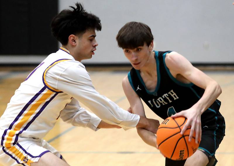Hononegah's Cole Warren tries to steal the ball from Woodstock North's Zaiden Vess during the 2025 Hoops for Healing tournament basketball game on Wednesday, Nov. 26, 2025, at Woodstock North High School.