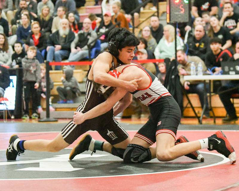 Jon Higueros of Joliet Catholic Academy, left, tries to control Ramsey Barton of Yorkville, during the 106-weight class during the regional meet on Tuesday Feb. 25, 2025, held at Yorkville High School.