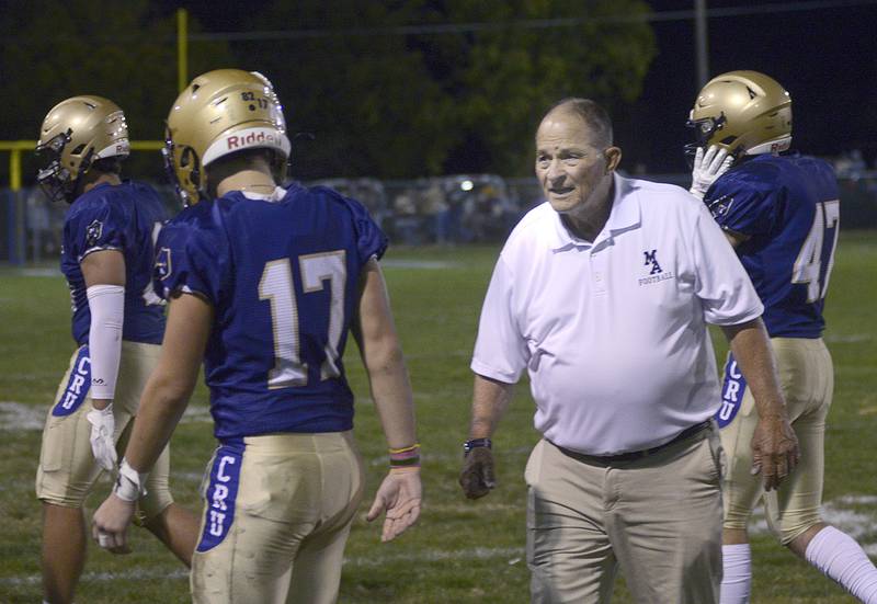 Marquette head Coach Tom Jobst address players after a change of possession Friday against  Aurora Central Christian.