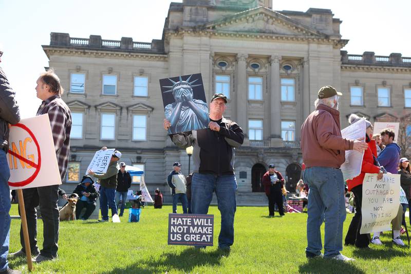 Steve Mooney, of Kankakee, holds a sign at the start of the No Kings rally at the Kankakee County Courthouse on March 28, 2026.