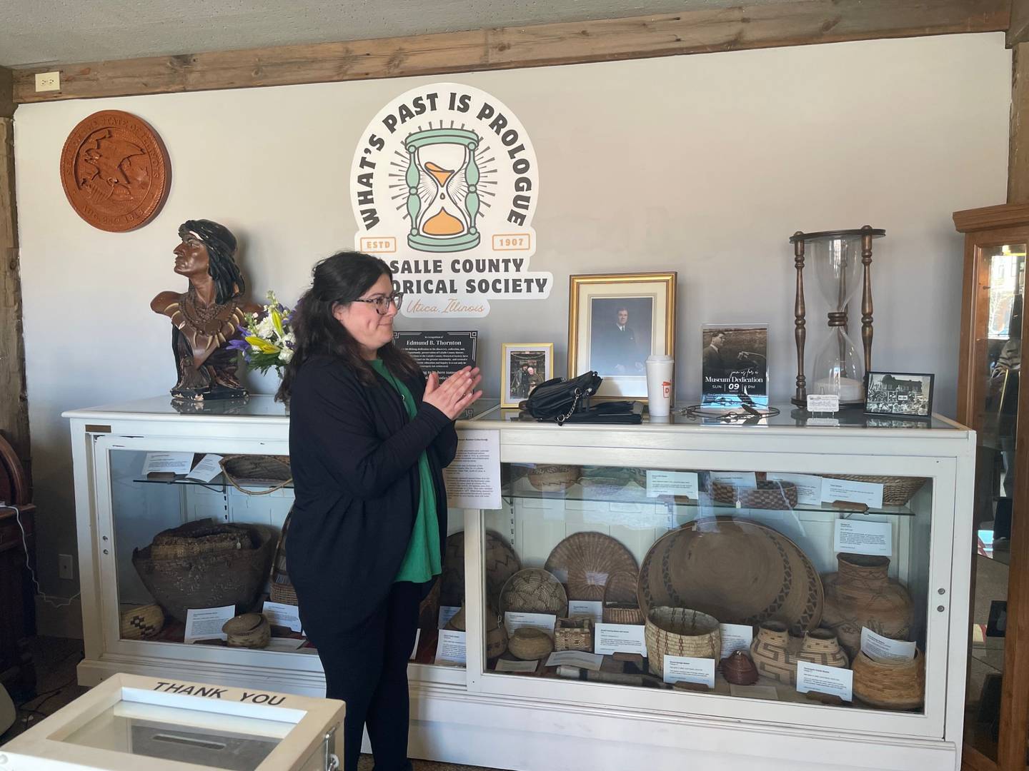 Amanda Carter, museum director of fthe La Salle County Historical Society, applauds during a dedication Sunday, March 9, 2025, renaming the society's primary museum as the Edmund B. Thornton Canal Warehouse Museum.