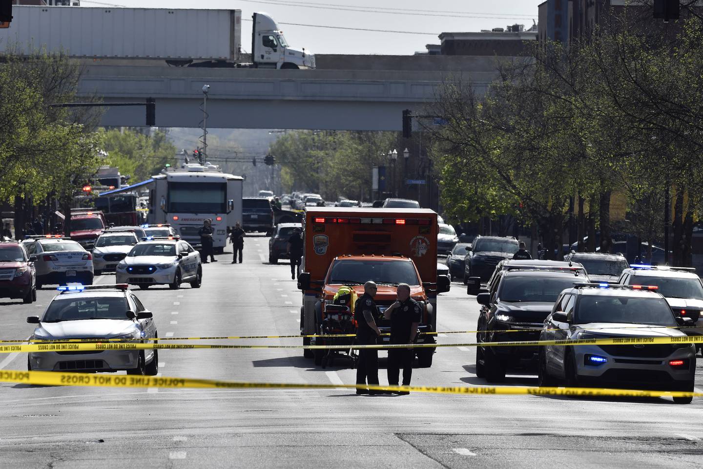 Louisville metro Police stand guard outside of the Old National Bank building in Louisville, Ky., Monday, April 10, 2023. (AP Photo/Timothy D. Easley)