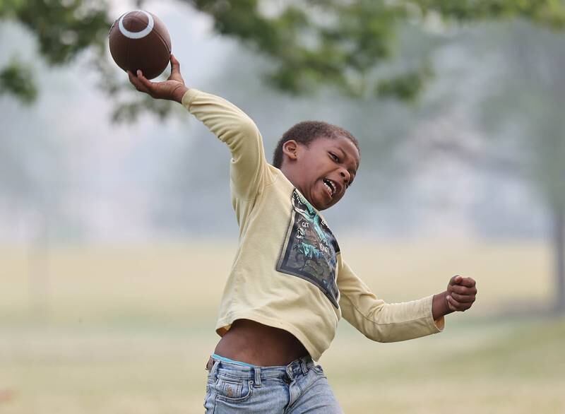 Zamir Tubbs, 7, from DeKalb, puts his all into a pass during Fun Jam in the Park Tuesday, June 27, 2023, at Welsh Park in DeKalb. Fun Jam in the Park offers constructive activities for kids on Tuesday and Thursday through August 8th from 5-7 p.m. at various parks in DeKalb.