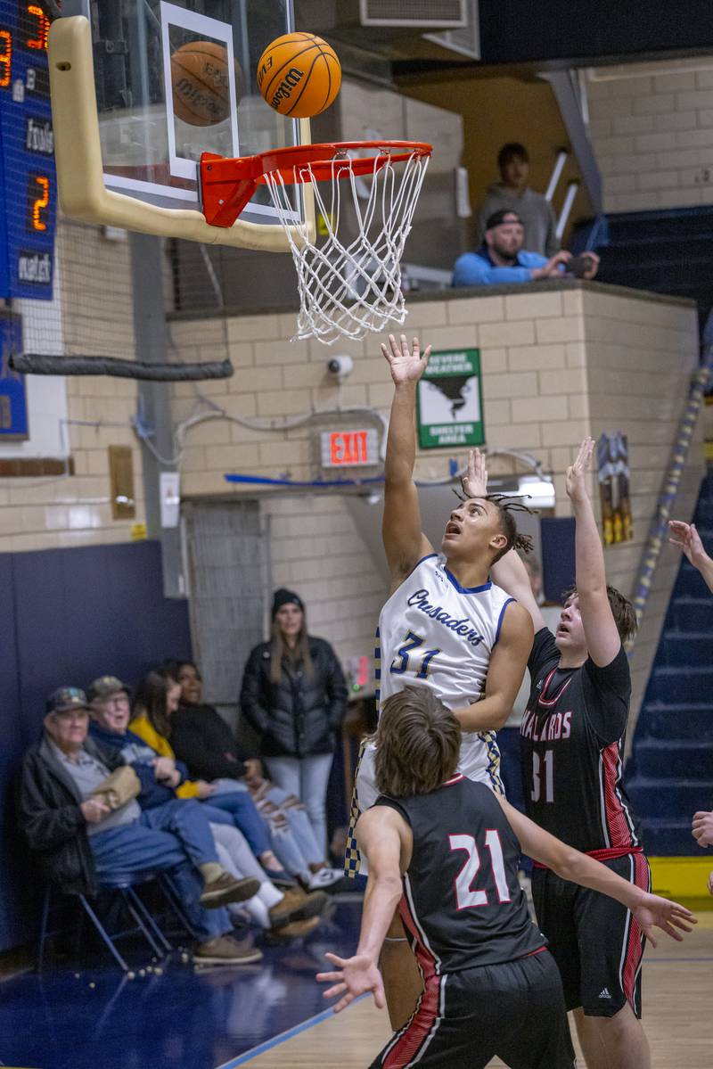 Markus Baker of Marquette takes a shot against Henry-Senachwine during the game on February 7, 2025 at Bader Gym.