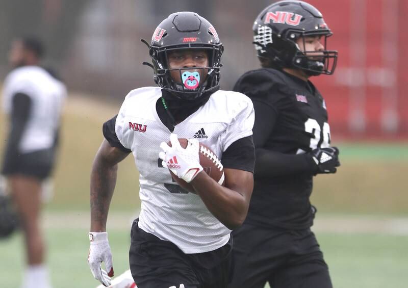 Northern Illinois University running back Mason Blakemore carries the ball during spring practice Wednesday, March 23, 2022, in Huskie Stadium at NIU in DeKalb.