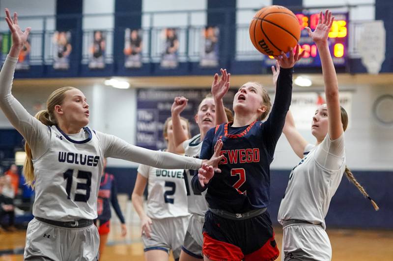 Oswego’s Ashley Cook (2) drives to the basket against Oswego East during a basketball game at Oswego East High School on Saturday, January 14, 2017.