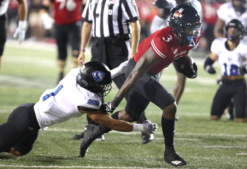 Northern Illinois Huskies running back Mason Blakemore shakes off Eastern Illinois Panthers safety Jordan Vincent on his way to a touchdown during their game Thursday, Sept. 1, 2022, in Huskie Stadium at NIU.