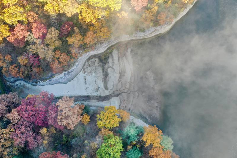 Fog begins to lift from the Illinois River between the top of Starved Rock and Eagle Cliff on Thursday, Oct. 24, 2024 in Starved Rock State Park.