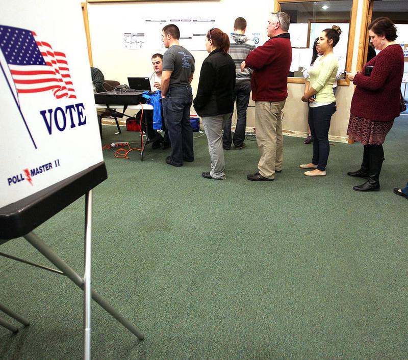 Voters stand in line before voting at the Evangelical Free Church of McHenry Tuesday, March 15, 2016. Polls in McHenry County stayed open until 8:30 p.m. Tuesday after problems with the electronic poll books in several precincts caused delays for some voters.