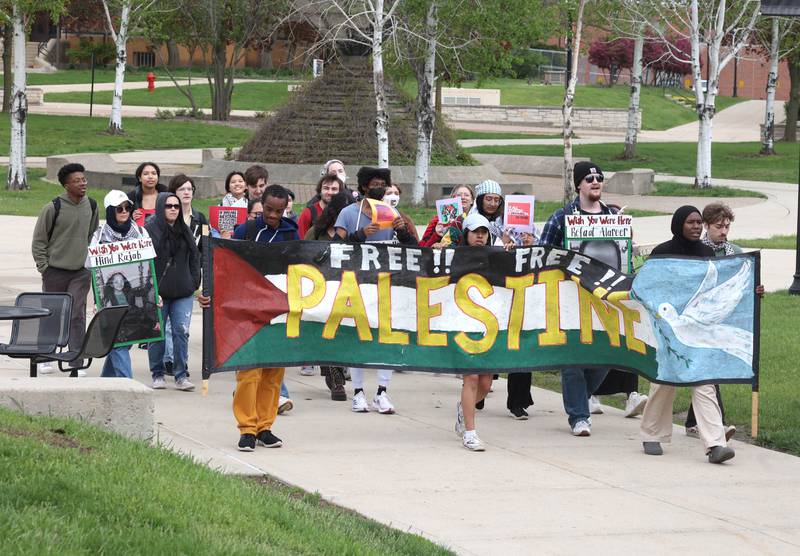 A group of about twenty demonstrators march through campus at Northern Illinois University Monday, April 29, 2024, to protest the Israel-Hamas War.