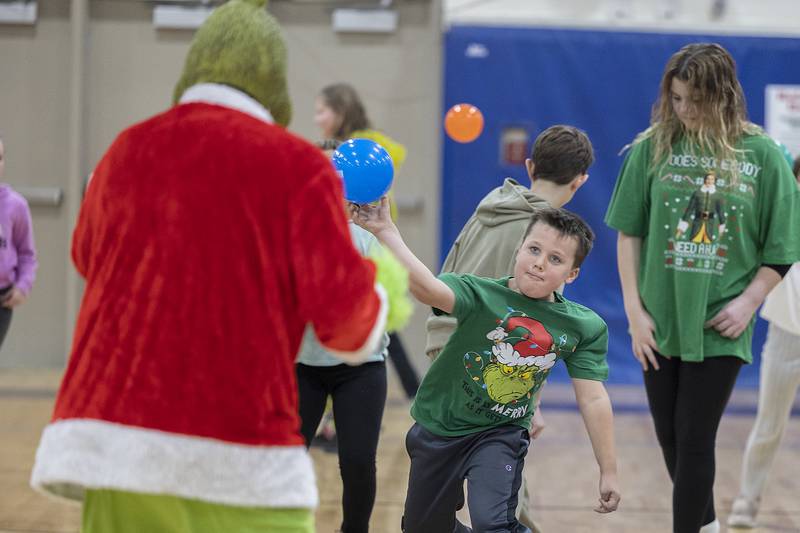 “Team Nice” members load up to pelt the Grinch Saturday, Nov. 23, 2024, during the Grinch’s dodgeball show down at Rock Falls Middle School. Kids of all ages had their chance to face off against the anti-Christmas figurehead.