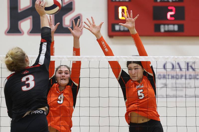 Lincoln-Way West's Kara Stigter, left, and Caroline Smith go for the block against Lincoln-Way Central on Tuesday, Sept. 24, 2024 in New Lenox.