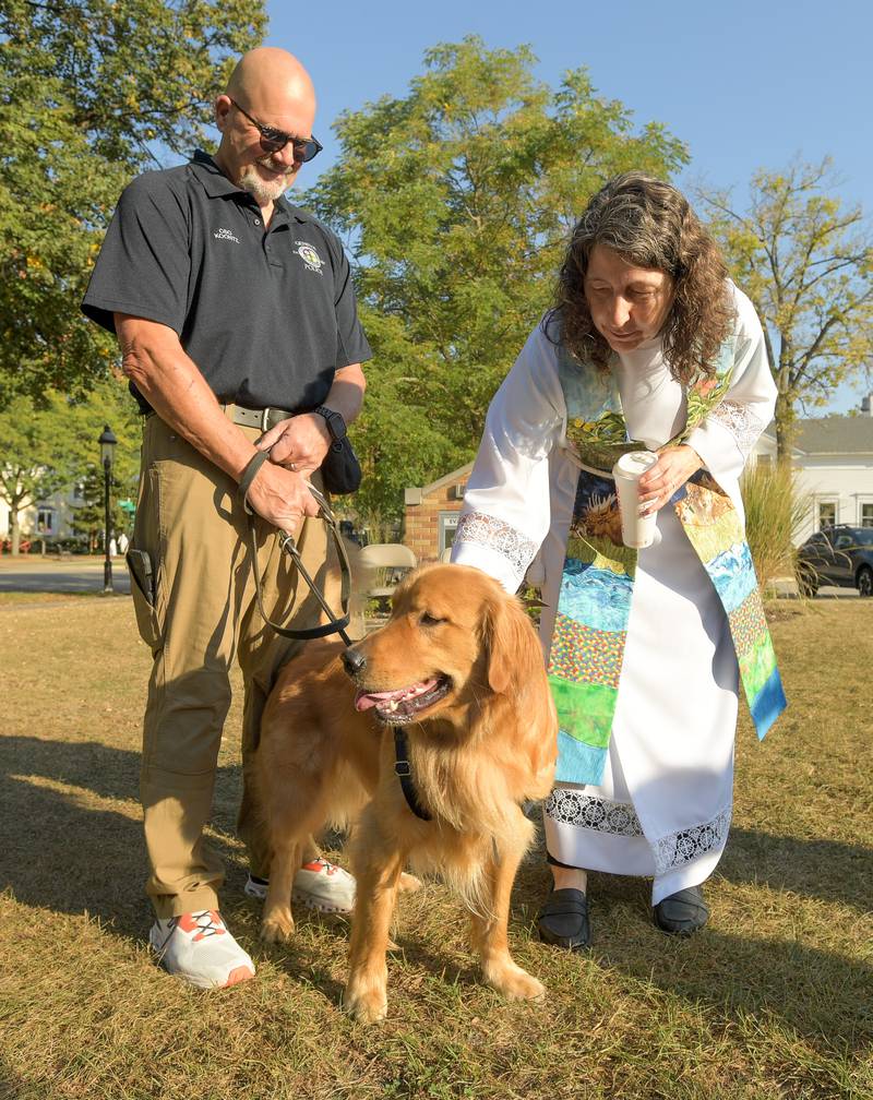 Pastor Trudy Stoffel from Geneva Lutheran Church blesses Geneva Police comfort dog “Tommy” with his handler Brad Koontz during their annual pet blessing service on Saturday, Oct 4, 2025 in Geneva.