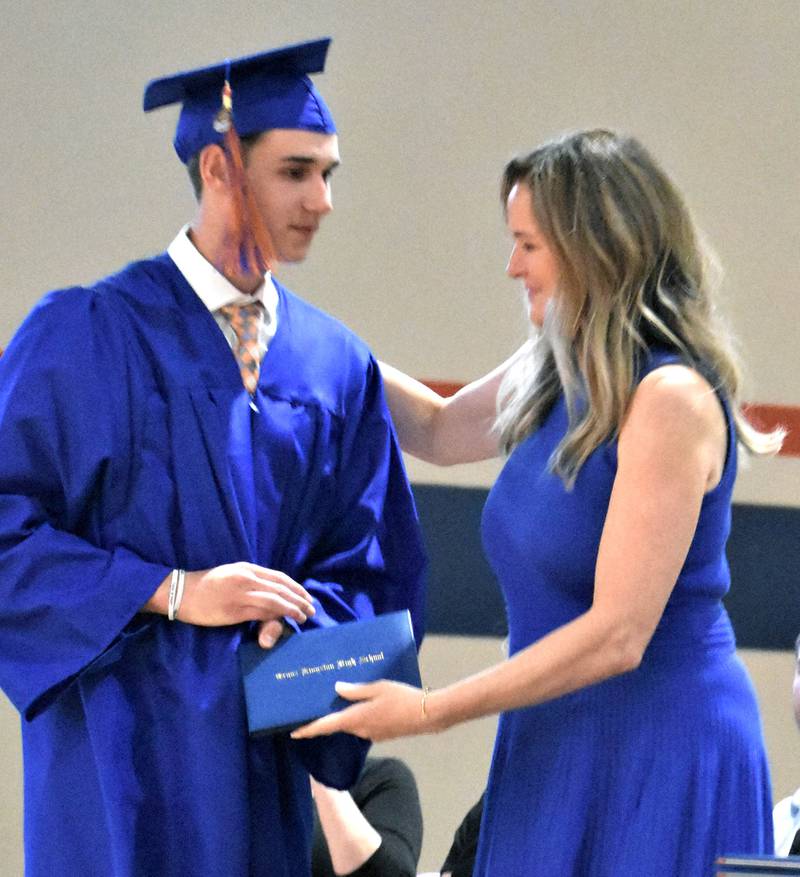 Genoa-Kingston’s Benjamin Kleba receives his diploma from his mother, Ruth Kleba, who is an employee of Genoa-Kingston School District, Sunday, May 17, 2026, during the commencment ceremony at Genoa-Kingston High School.