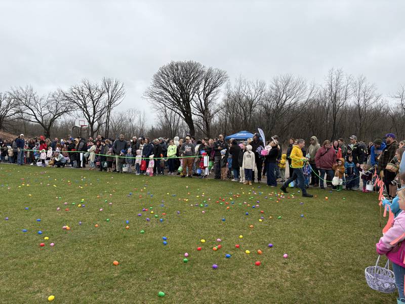Volunteers remove plastic rope before the Easter Egg Hunt at Sunnyside Memorial Park in Johnsburg, Saturday, April 4, 2026.