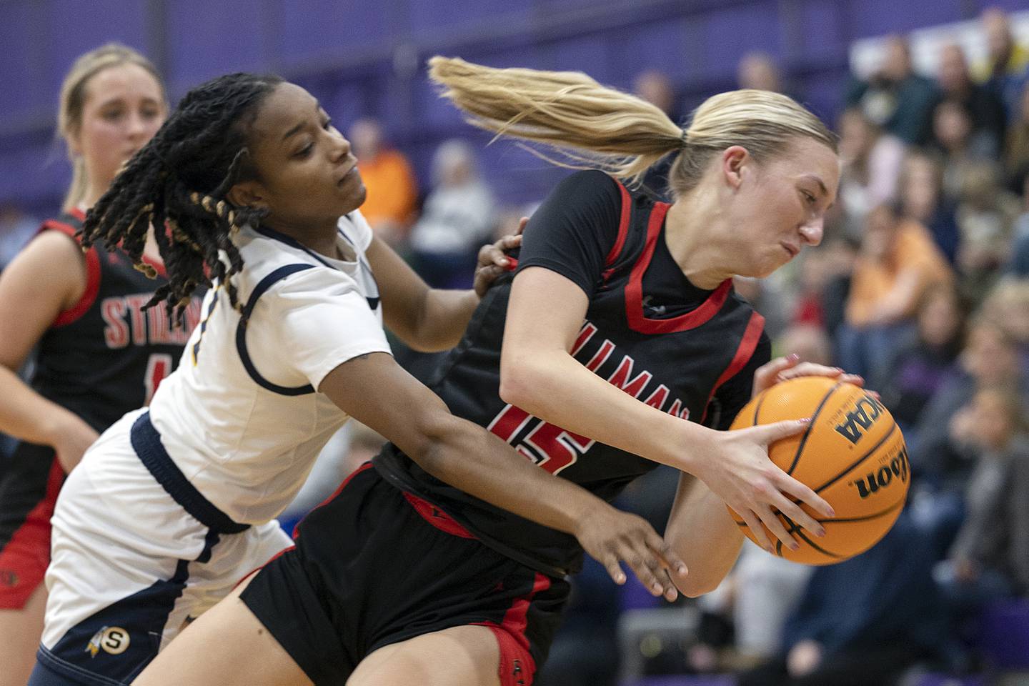 Sterling’s Taah Liberty and Stillman Valley’s Taylor Davidson fall out of bounds battling for a ball Friday, Dec. 27, 2024, during the Dixon Girls KSB Holiday Basketball Classic.