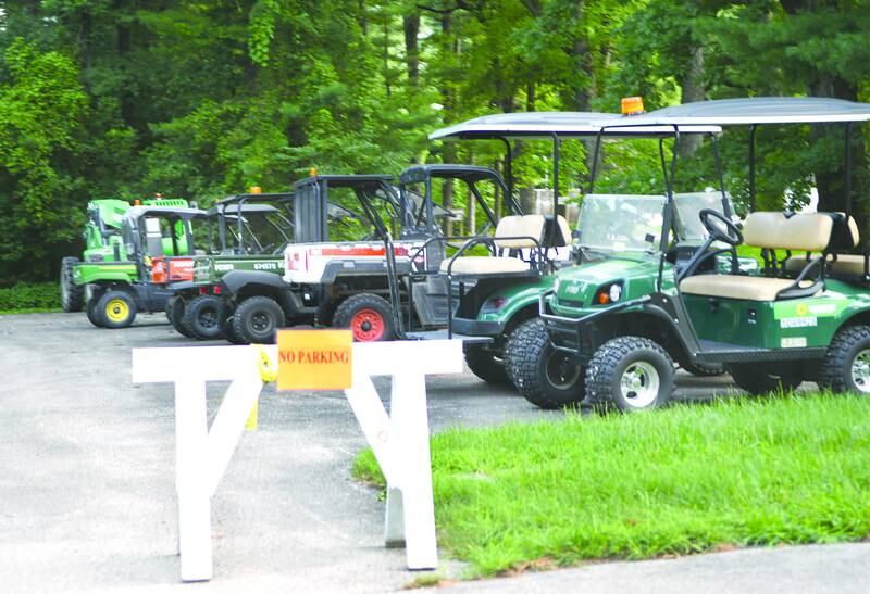 Golf carts and ATVs are staged in one of the parking lots near the lodge at White Pines State Park in 2018.