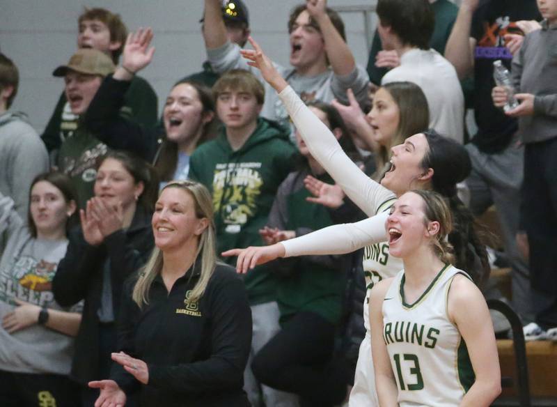 St. Bede Lady Bruin basketball players Ali Bosnich and Ashlyn Ehm react with head coach Stephanie Mickley and superfans during the final minute of the game against Putnam County in  the Tri-County Conference Tournament championship on Thursday, Jan. 18, 2024 at Henry-Senachwine High School.
