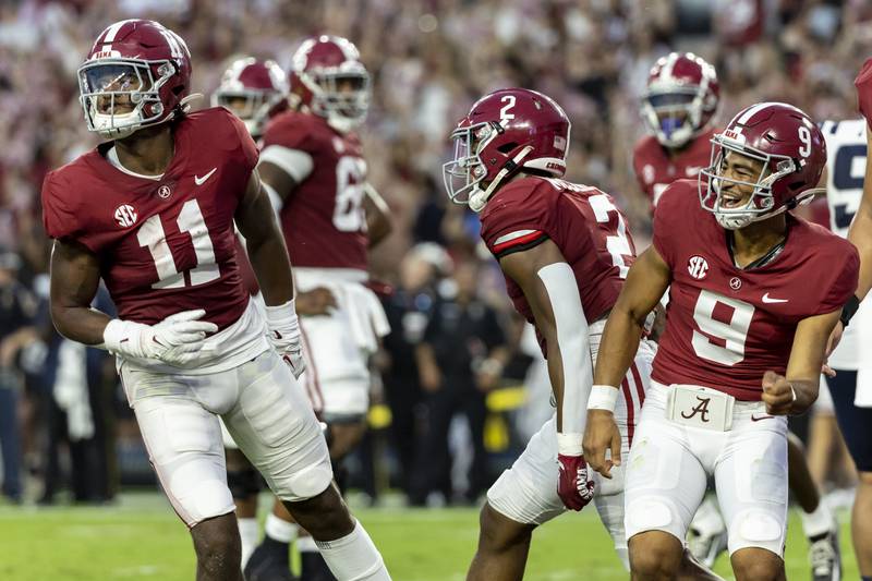 Alabama wide receiver Traeshon Holden (11) and quarterback Bryce Young (9) celebrate after combining on a touchdown pass during the first half of an NCAA college football game against Utah State, Saturday, Sept. 3, 2022, in Tuscaloosa, Ala. (AP Photo/Vasha Hunt)