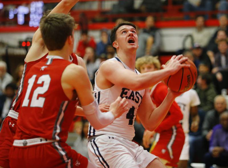 Oswego East's Tyler Jasek (4) takes a shot from under the basket during the Hinsdale Central Holiday Classic championship game between Oswego East and Hinsdale Central high schools on Thursday, Dec. 29, 2022 in Hinsdale, IL.
